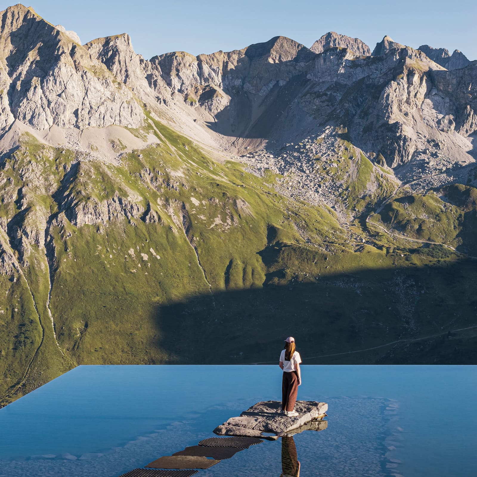 A Mirrored Pool Transforms Infrastructure Into Alpine Experience